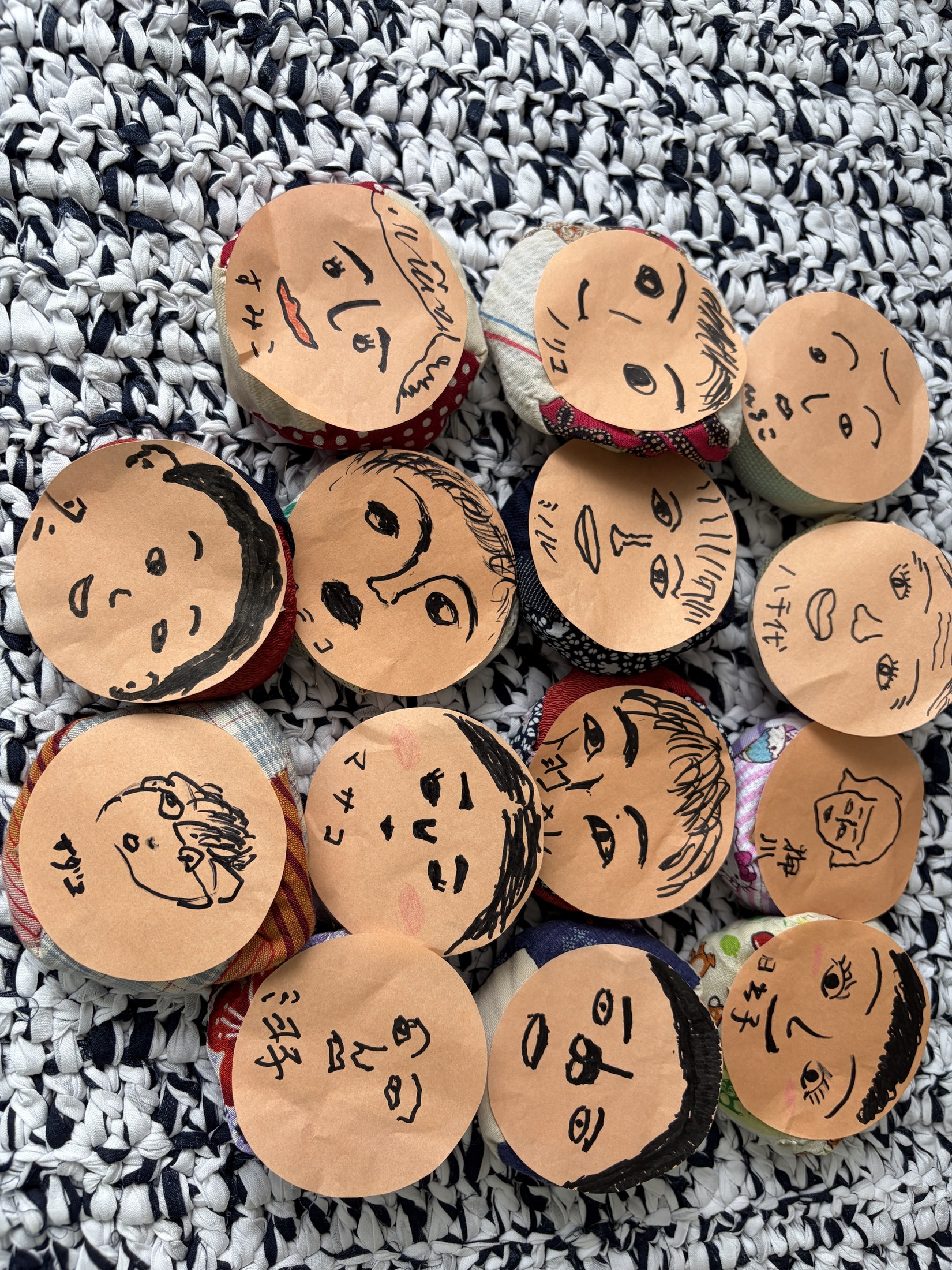 利用者さんが自分の顔を描いて作った、すごろく用の布製の駒